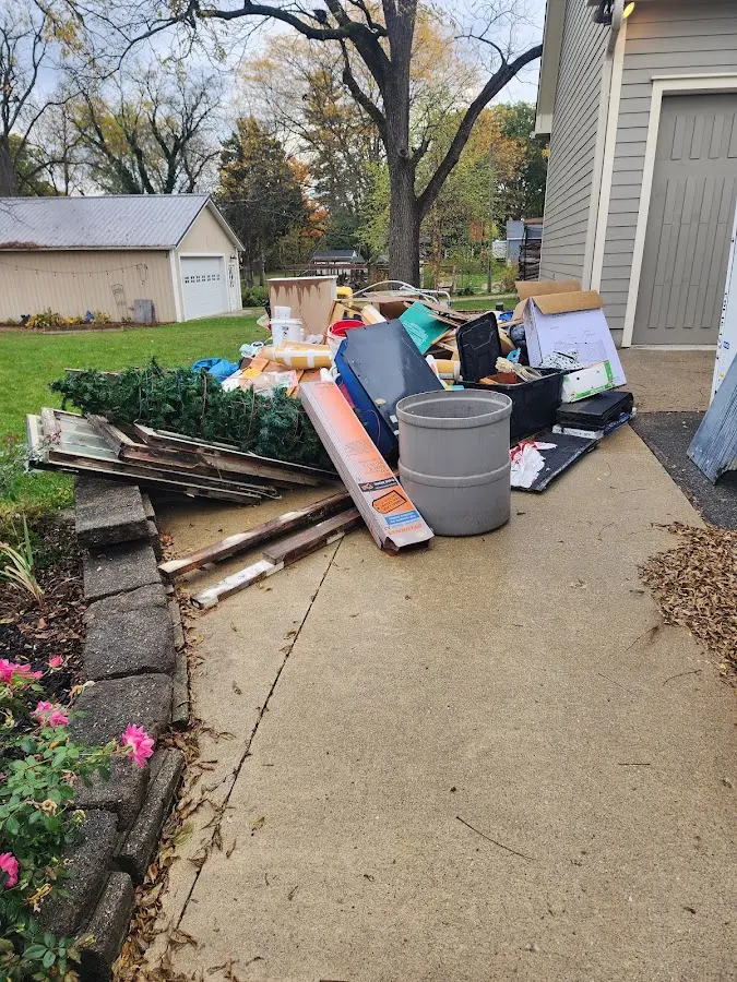 Dumpster being loaded with debris for Roofing Dumpster Rental in Little Ferry